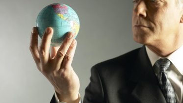 Business-Man-Holding-Globe-Business